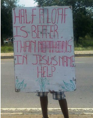 A beggar's placard on William Nicol Drive, Sandton